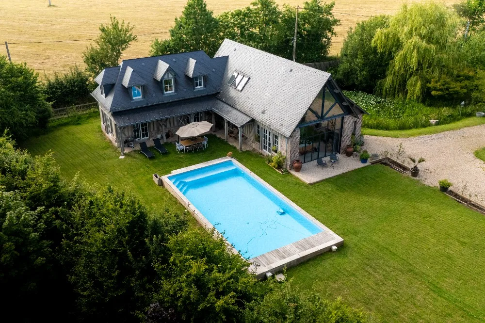 Vue aérienne d’une maison avec piscine et jardin en campagne